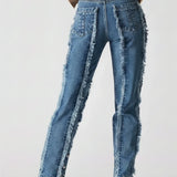 Blue distressed jeans worn by a person on a white background