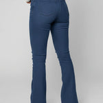 Person wearing blue flared jeans on a plain background
