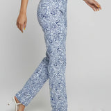 Person wearing blue floral pants on a plain background