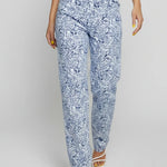 Person wearing blue floral pants on a white background