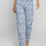 Person wearing blue floral pants on a white background