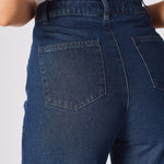 A zoomed in shot of the rear pockets and stitching on the blue high waisted wide leg cargo denim jeans.