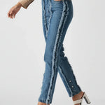 Person wearing blue jeans and a beige shirt on a white background