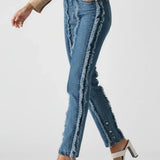 Person wearing blue jeans and a beige shirt on a white background