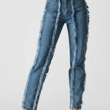 Blue jeans with frayed edges worn by a person on a white background