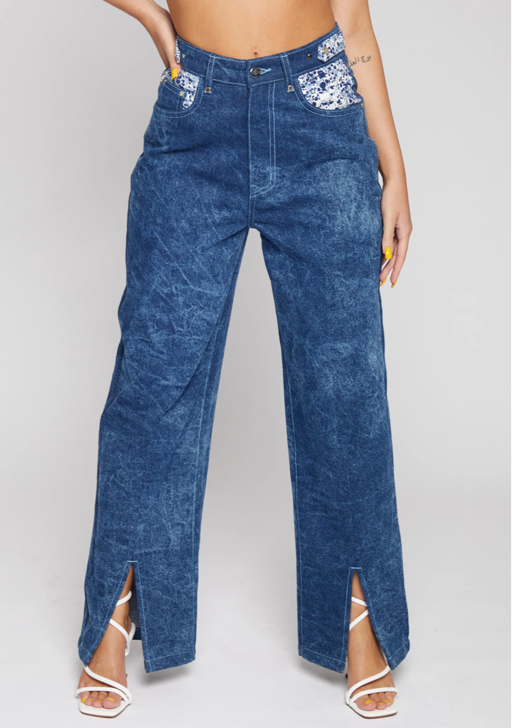 Angled back view showing silver embellished pocket details on blue wide leg jeans