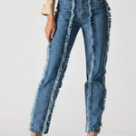Person wearing blue jeans with frayed edges on a white background
