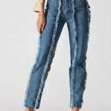 Person wearing blue jeans with frayed edges on a white background
