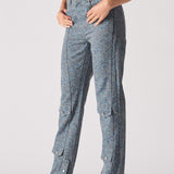 Person wearing blue pants with button details on a plain background