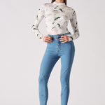 Full front view of a model wearing the blue skinny jeans in a high-waisted fit.
