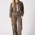 A woman wearing high-waisted wide leg brown cargo jeans for women with a matching denim jacket.