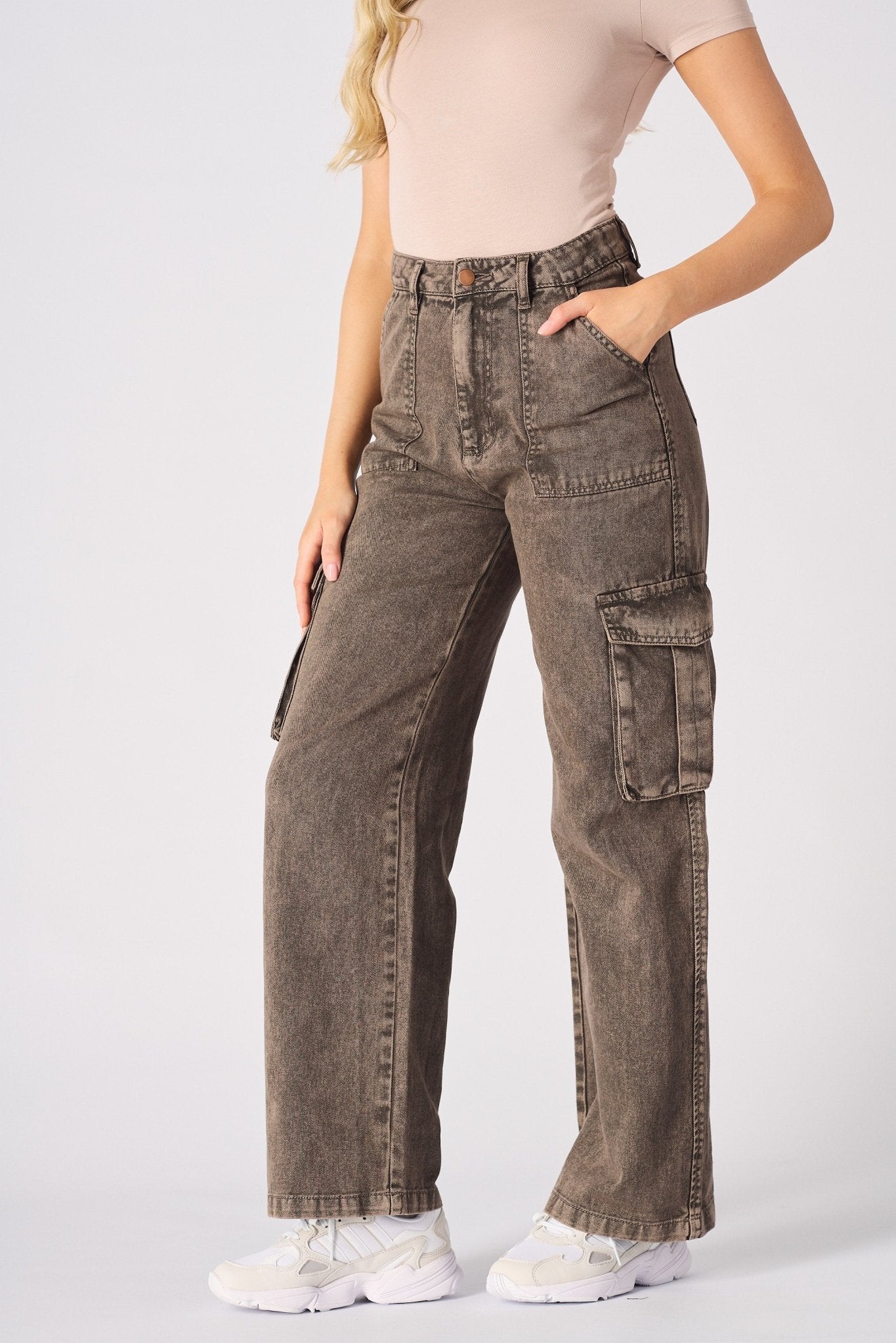 Side view of the brown cargo jeans for women highlighting the wide leg fit and utility pockets.