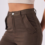Detailed shot of the high waisted button closure and secure fit on the brown cargo jeans.