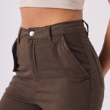 Detailed shot of the high waisted button closure and secure fit on the brown cargo jeans.