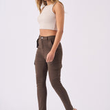 A model walking to show the flexible fit and movement of the brown cargo jeans for women.