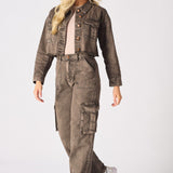 A model walking in brown cargo jeans for women styled with white trainers and a beige top.