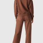 Rear view of an oversized brown crew neck jumper for women showing the relaxed fit