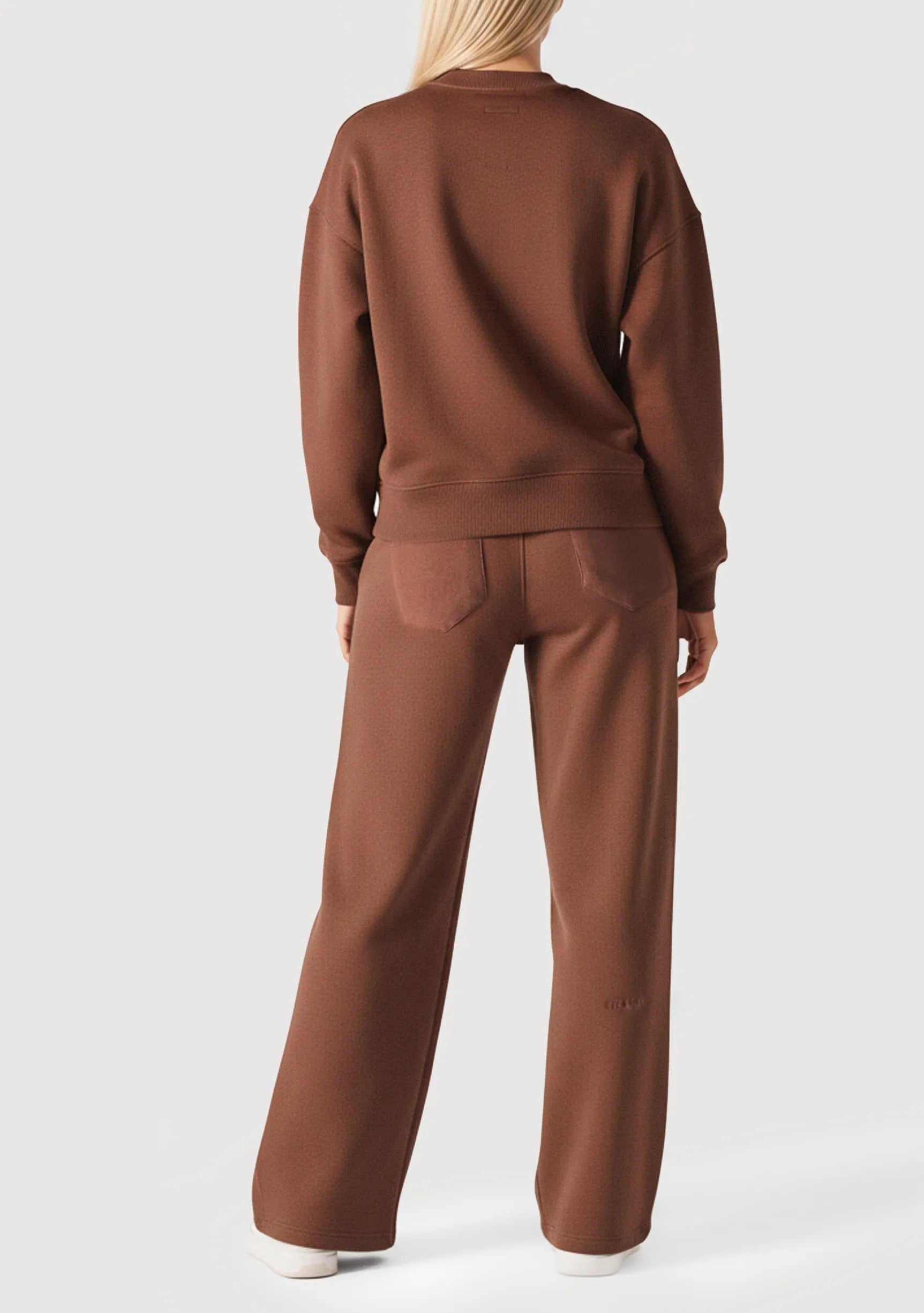 Rear view of an oversized brown crew neck jumper for women showing the relaxed fit