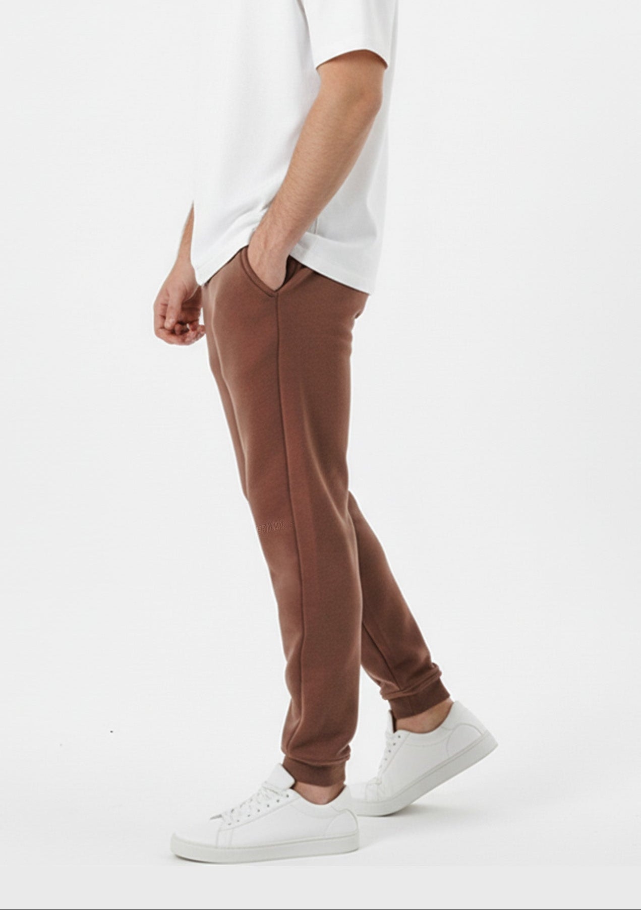 Brown tapered joggers side close up showing ribbed cuffs