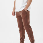 Brown tapered joggers side walking pose