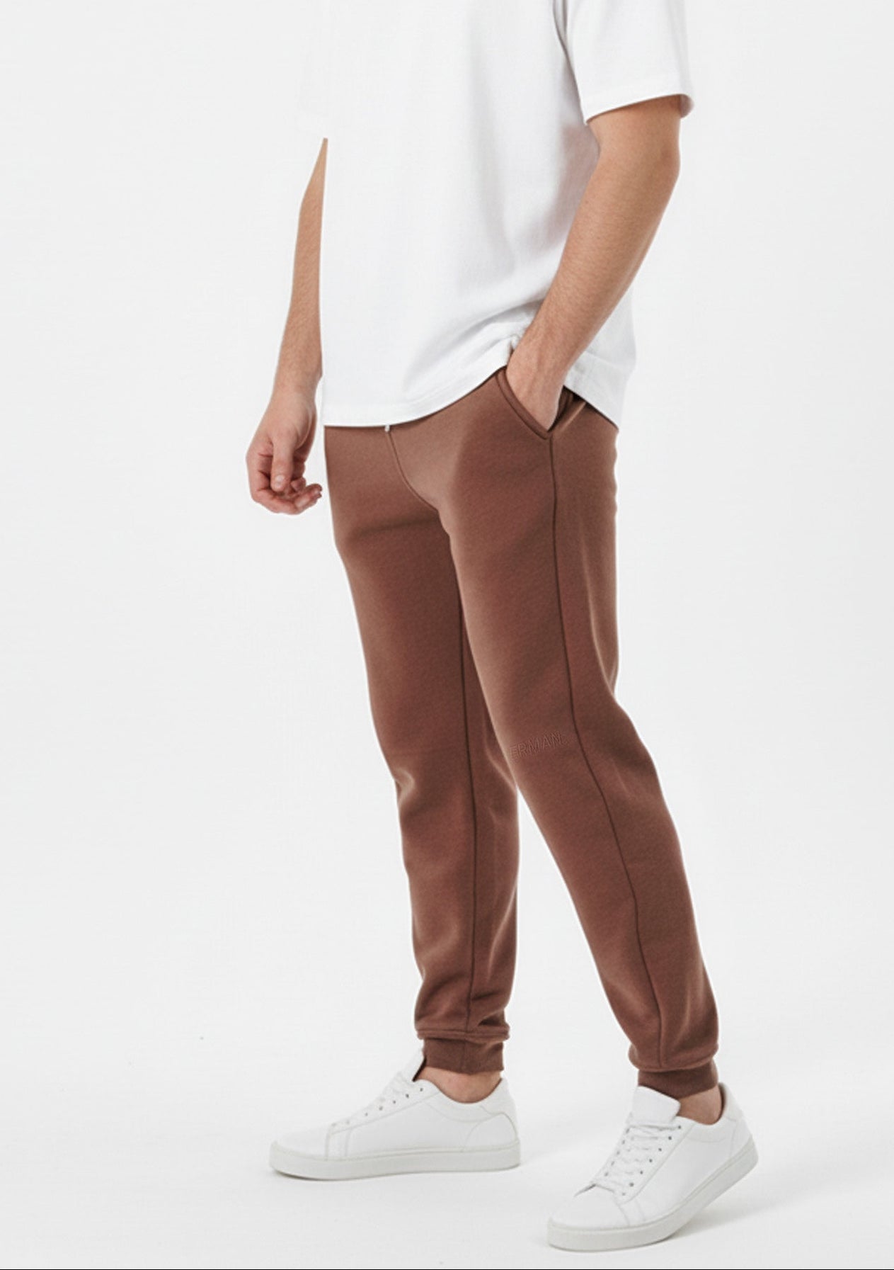Brown tapered joggers side walking pose