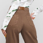 Close up of back pockets and leather brand patch on mocha brown wide leg pants