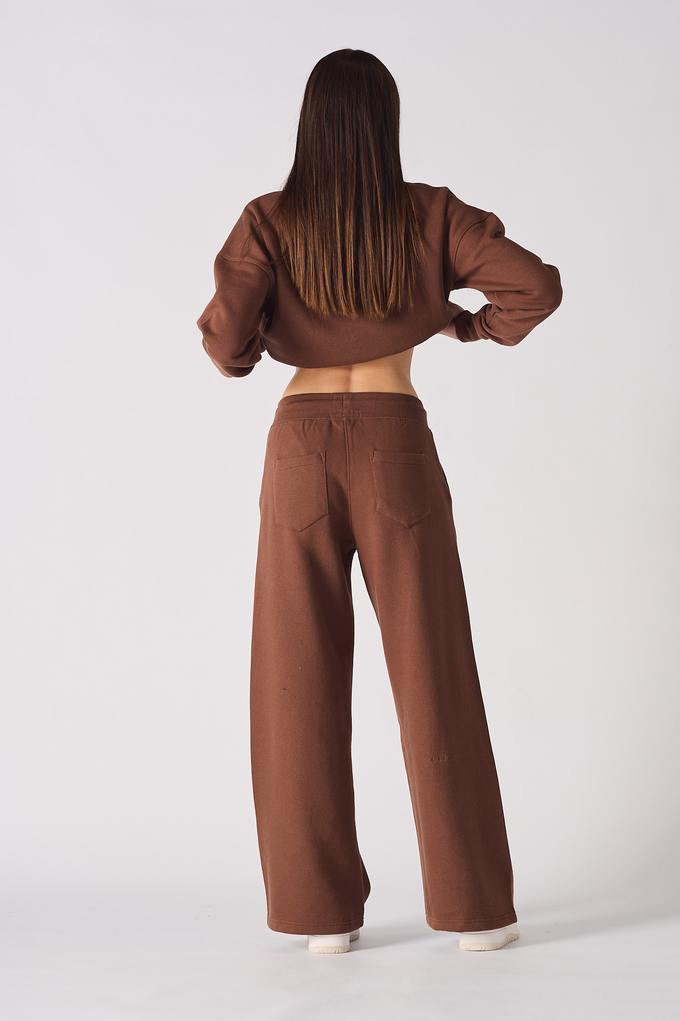 Rear view of chocolate brown wide leg joggers with a matching cropped hoodie