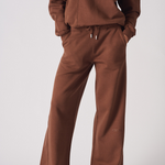 Full front view of a woman wearing a matching chocolate brown jogger set
