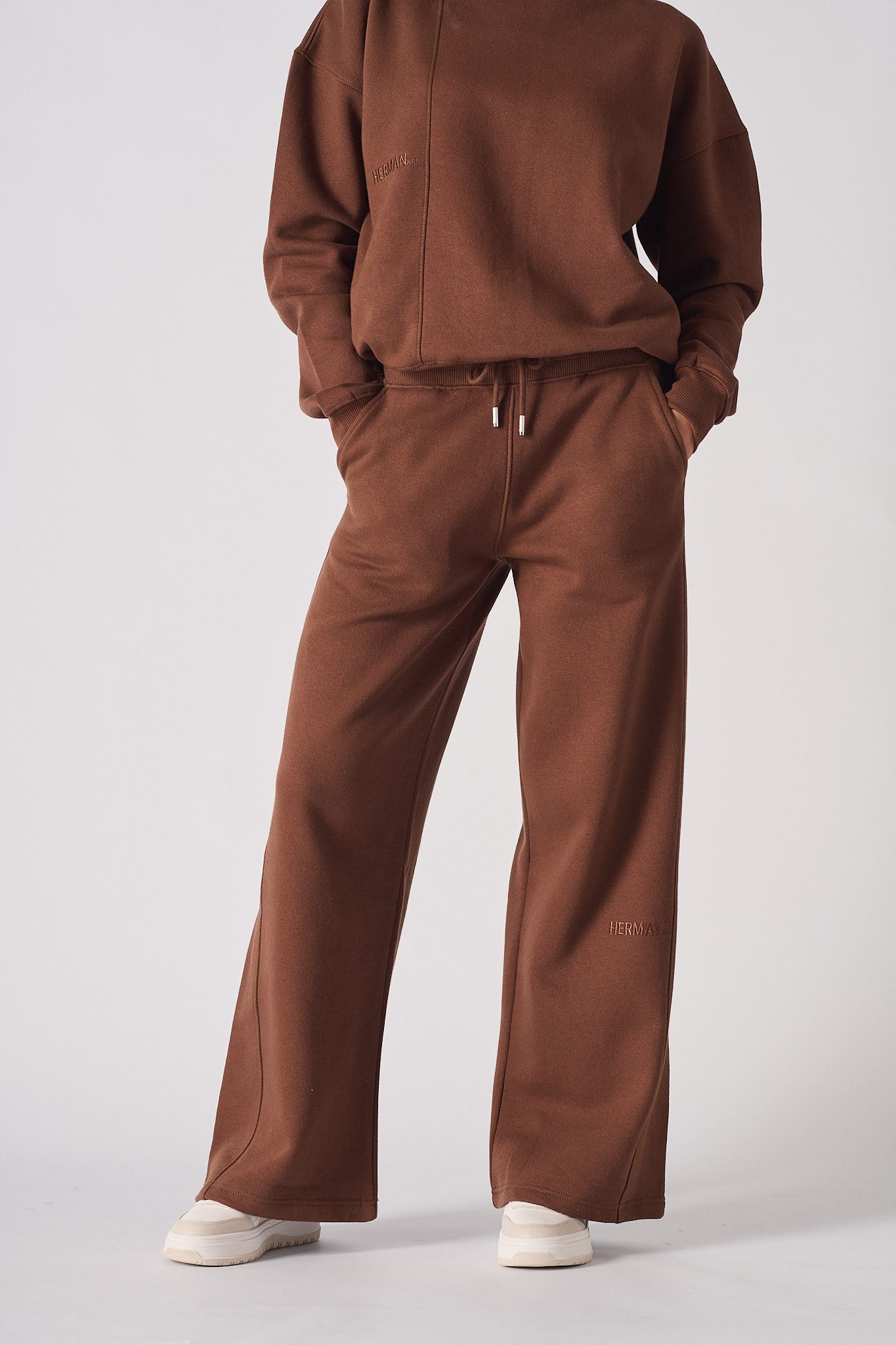 Full front view of a woman wearing a matching chocolate brown jogger set