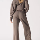 Rear view of the gracefully tailored brown wide leg joggers women.
