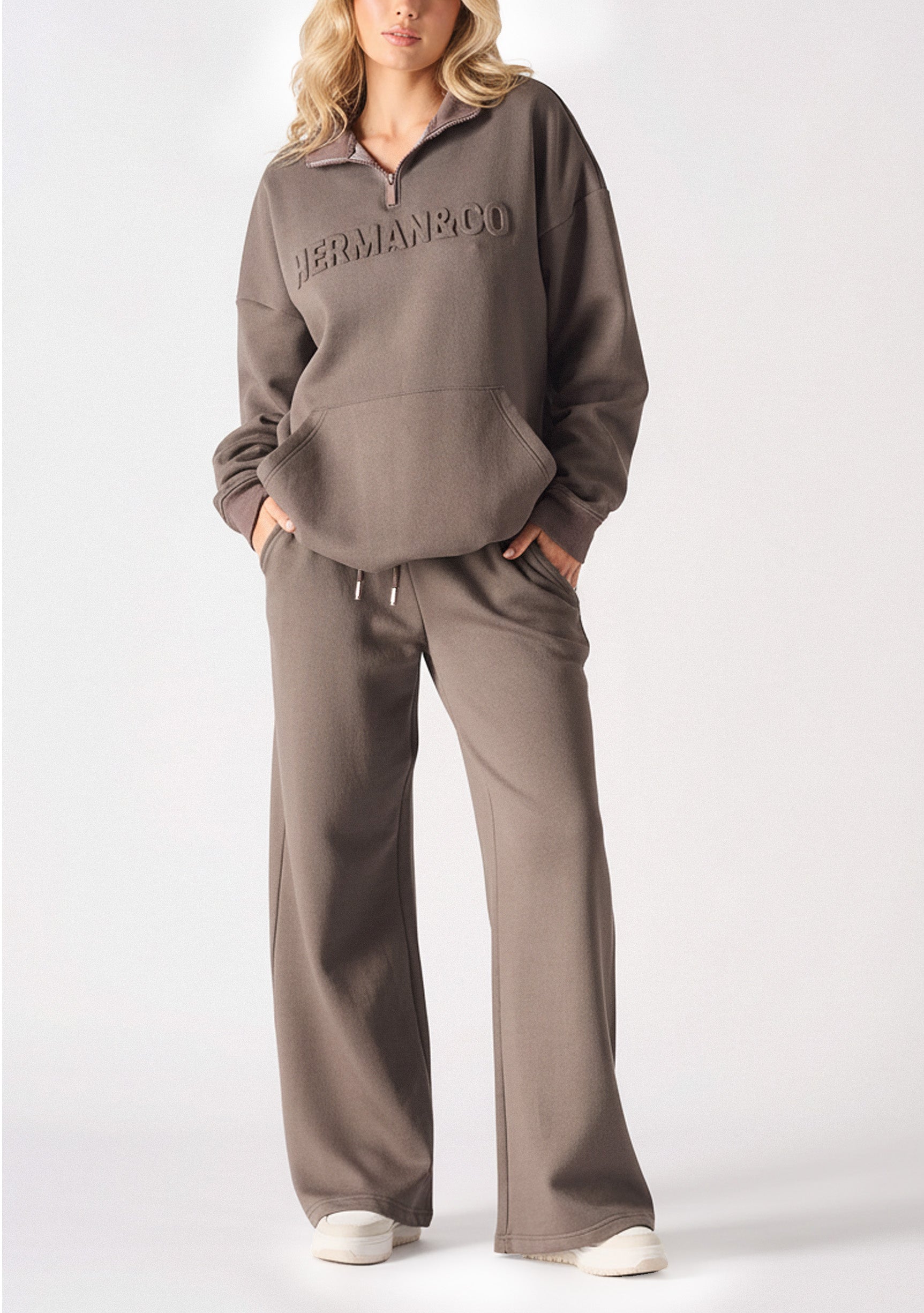 Full body view of a model in brown wide leg joggers women and a matching hoodie.