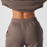 Close up showing the high rise back waist of the brown wide leg joggers women.