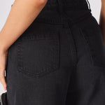 Back view of the high-waisted black cargo jeans showing pocket placement and denim finish.