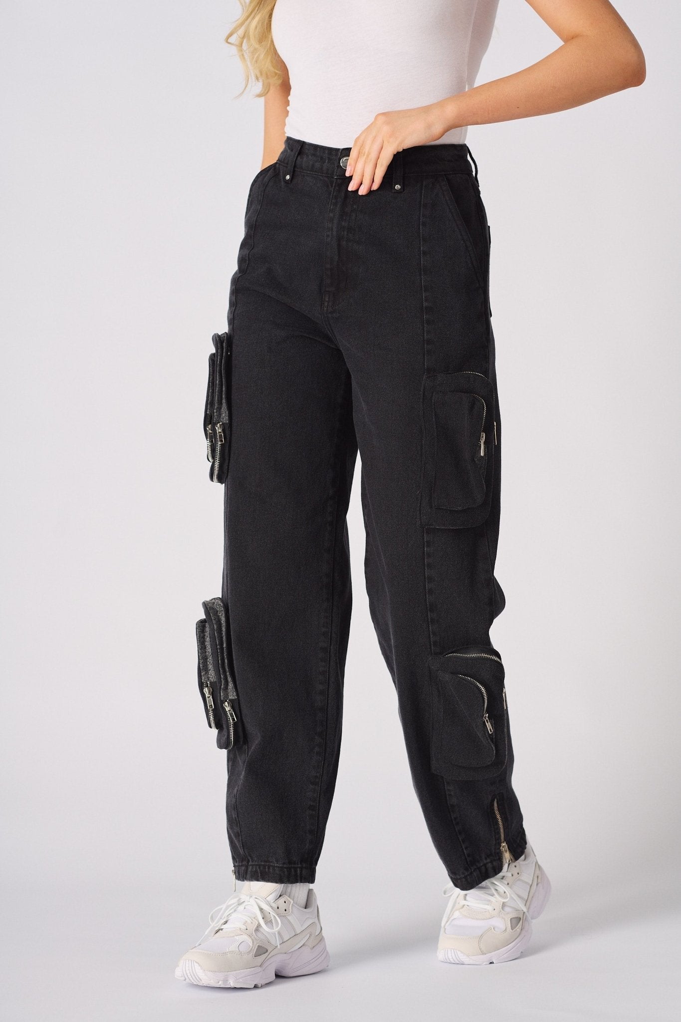 Front view of relaxed straight-leg black cargo jeans showing the functional utility pockets.