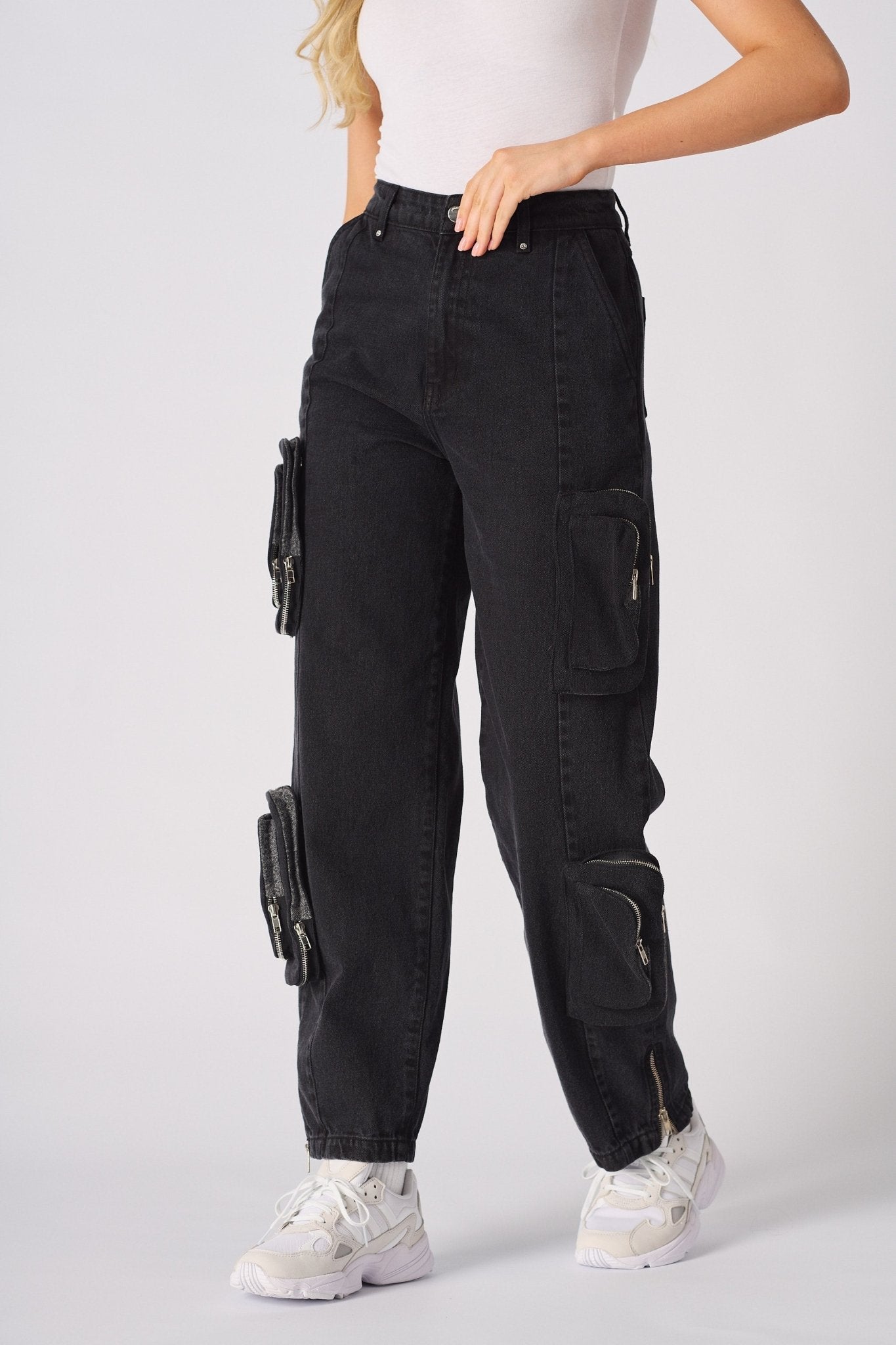 Front view of relaxed straight-leg black cargo jeans showing the functional utility pockets.