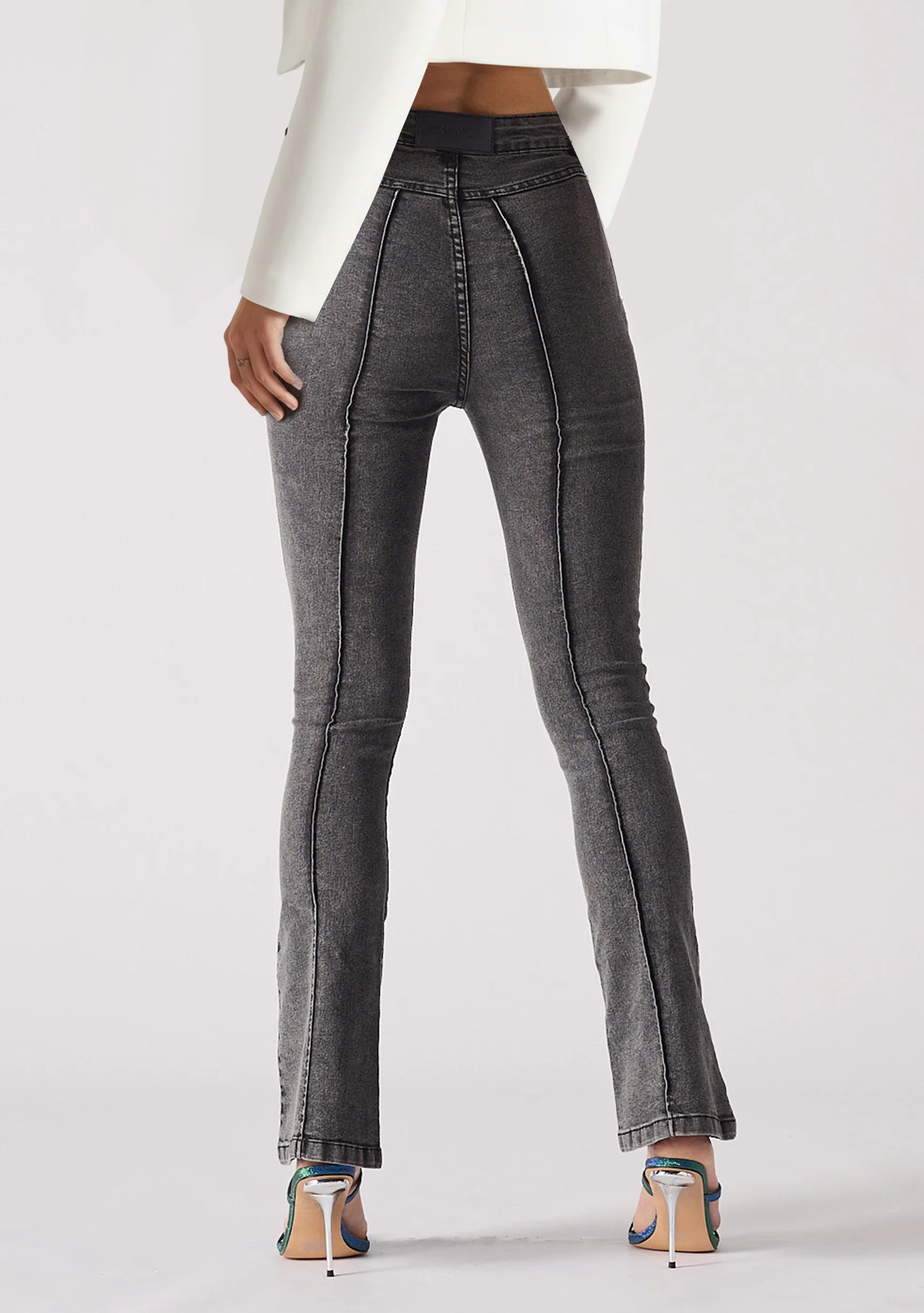Back view of women's grey bootcut jeans featuring a clean pocketless design