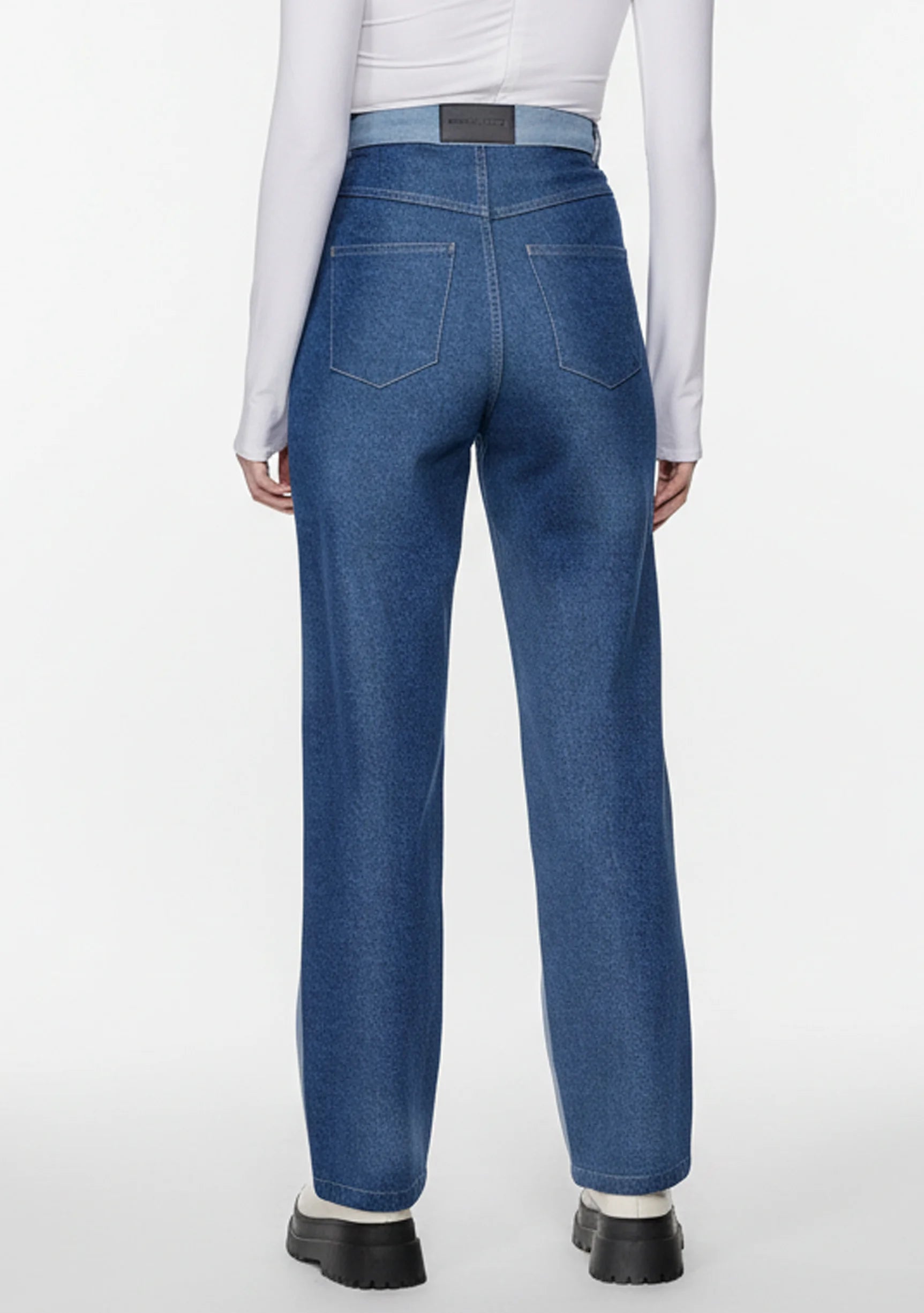 Full back view of women's high-waisted color-block jeans in dark blue denim