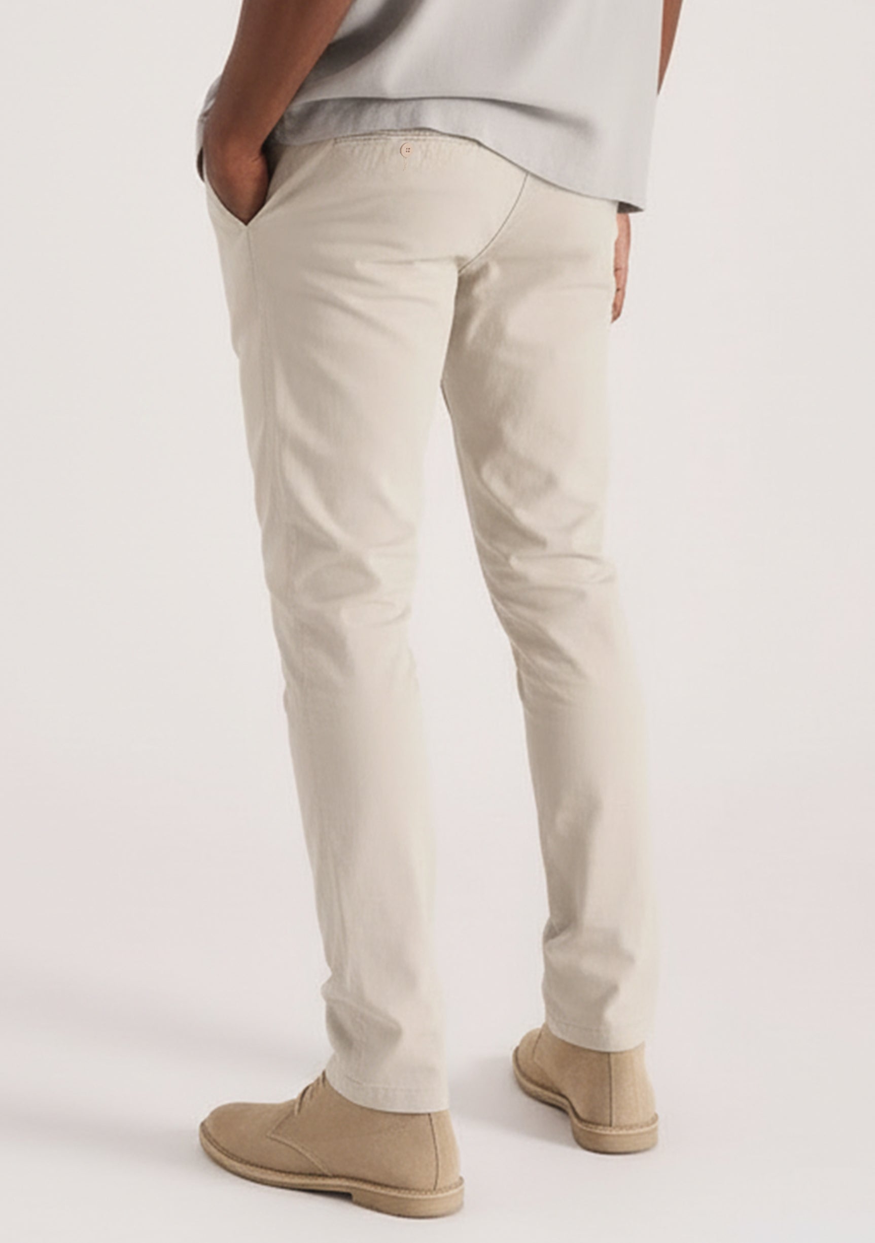 Detail view of the back pockets on stylish cream chinos for men by Jmojo.