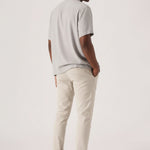 Close-up front view of cream chinos men showcasing the tailored stretch fit.