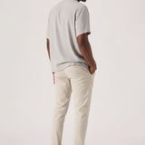 Close-up front view of cream chinos men showcasing the tailored stretch fit.