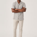 Full front view of a man standing in casual stretch cream trousers by Jmojo.