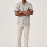 Full front view of a man standing in casual stretch cream trousers by Jmojo.