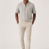 Full back view of a model wearing stretch slim fit cream trousers mens.