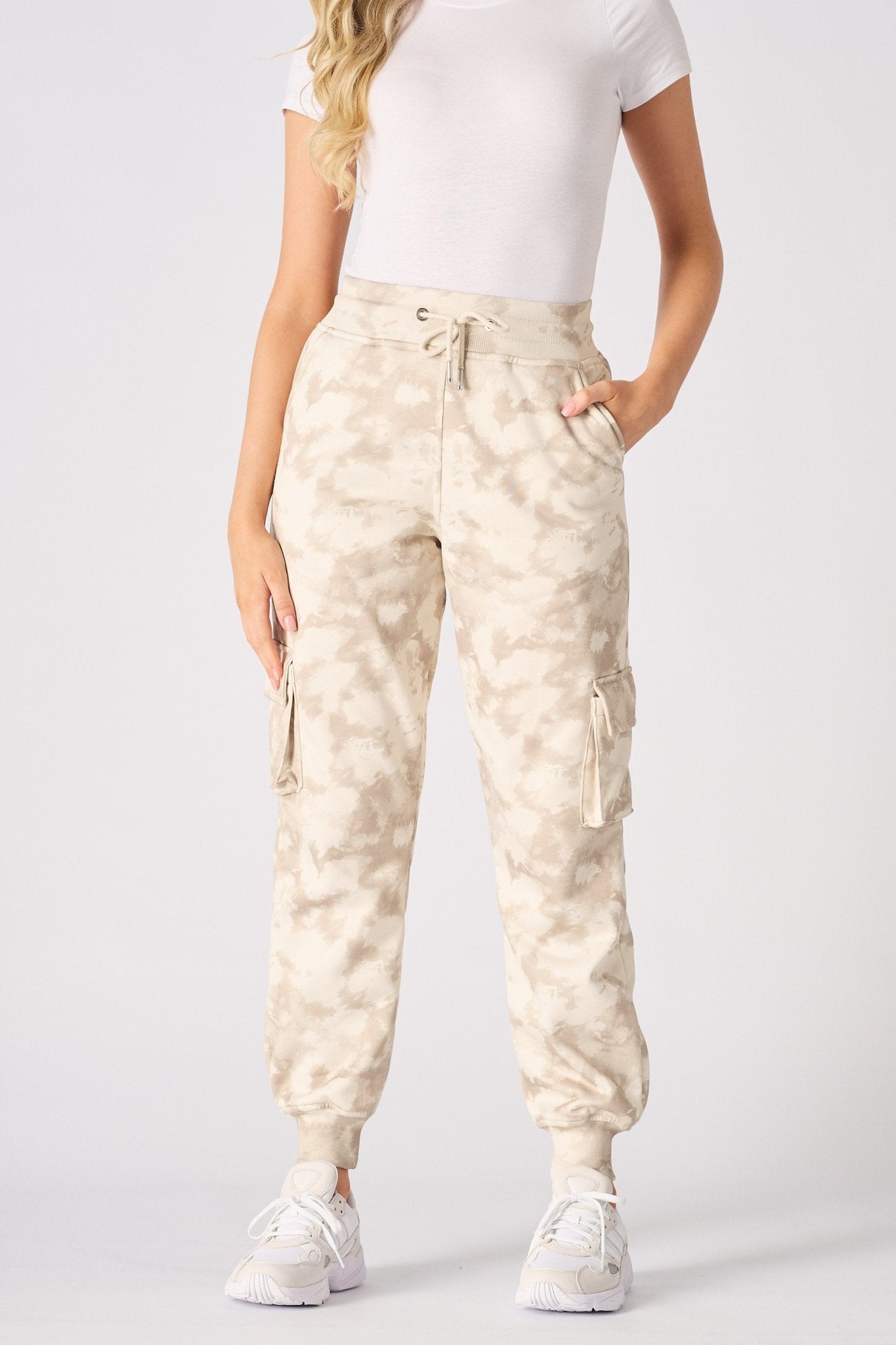 Close up of the practical cargo pocket on the beige tie dye joggers