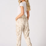 Rear view of the tapered fit on these beige cuffed cargo joggers