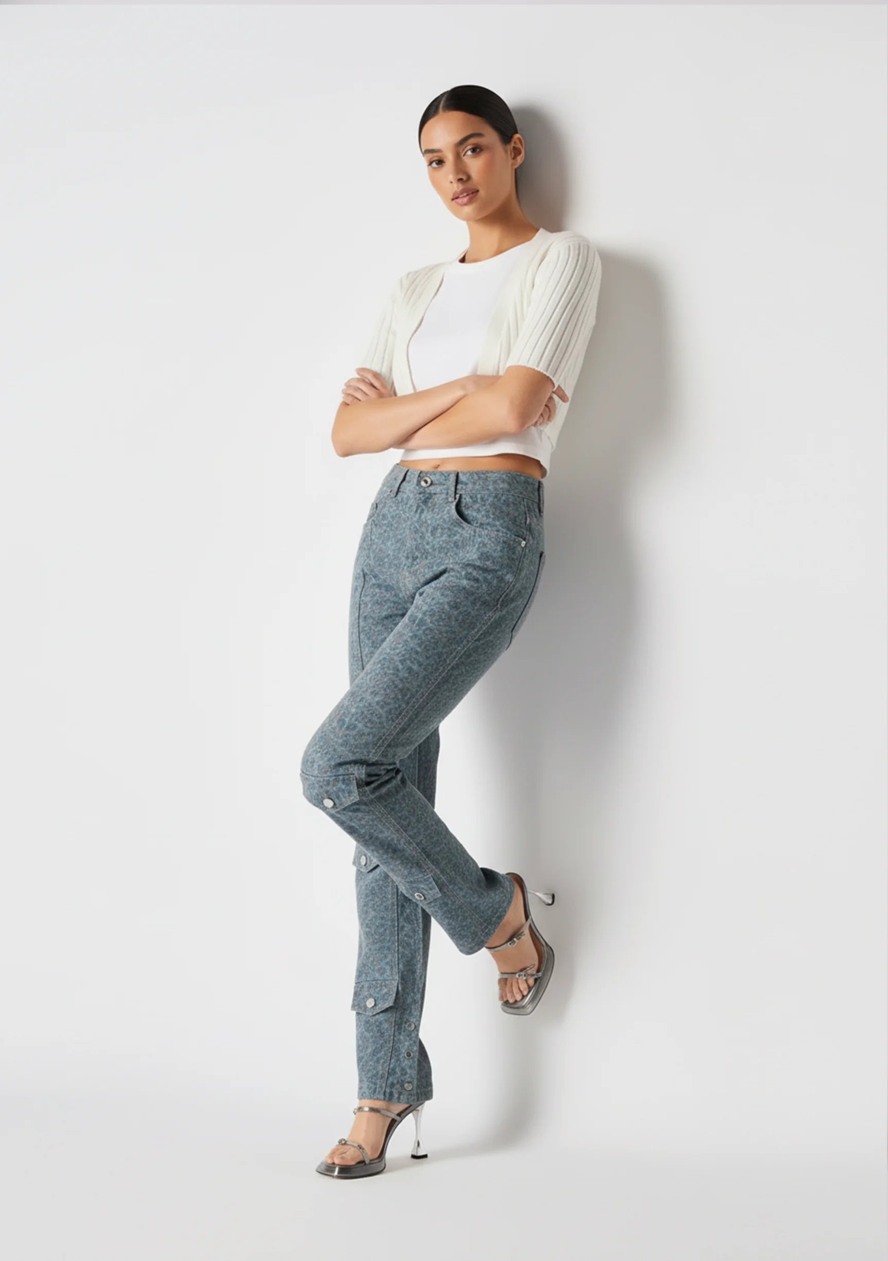 Model leaning on a wall in Dark Blue and Grey Speckled Women's Denim