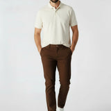 Front view of a man walking in mens dark brown smart trousers