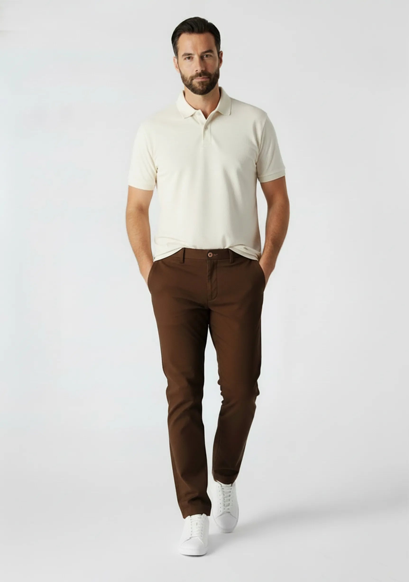 Front view of a man walking in mens dark brown smart trousers