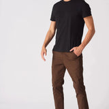 Side angle of a model wearing dark brown slim fit chinos.