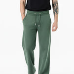 side angle view showing wide leg fit on dark green joggers